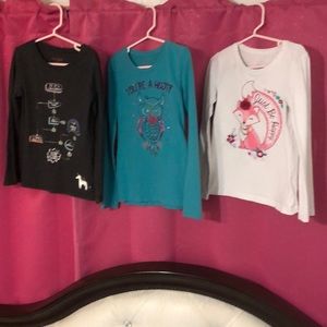 A bundle of girls long sleeve shirts.